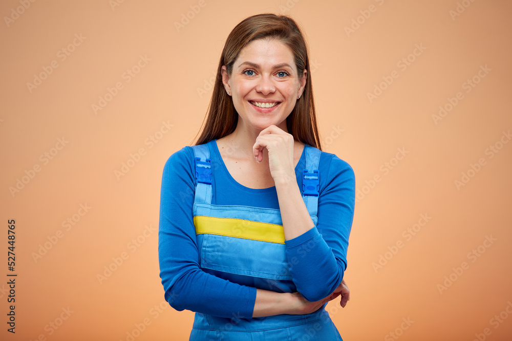 Thinking woman builder or student in overalls. Isolated female portrait in work uniform.