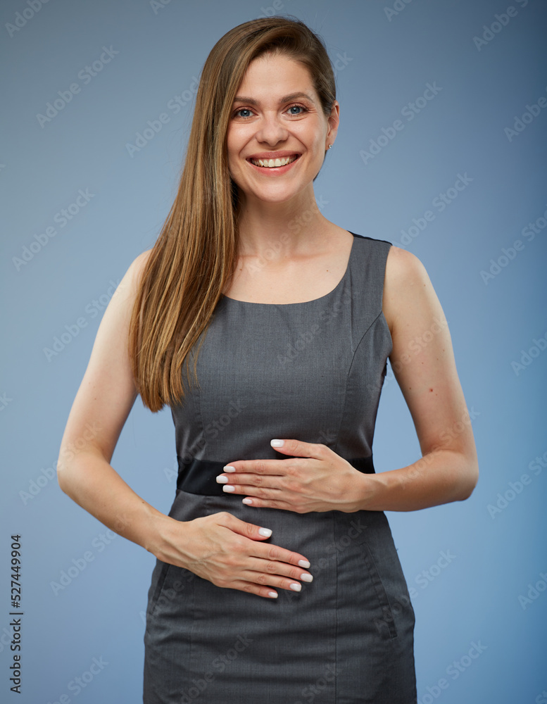 Smiling happy woman holding hands on stomach. isolated portrait.
