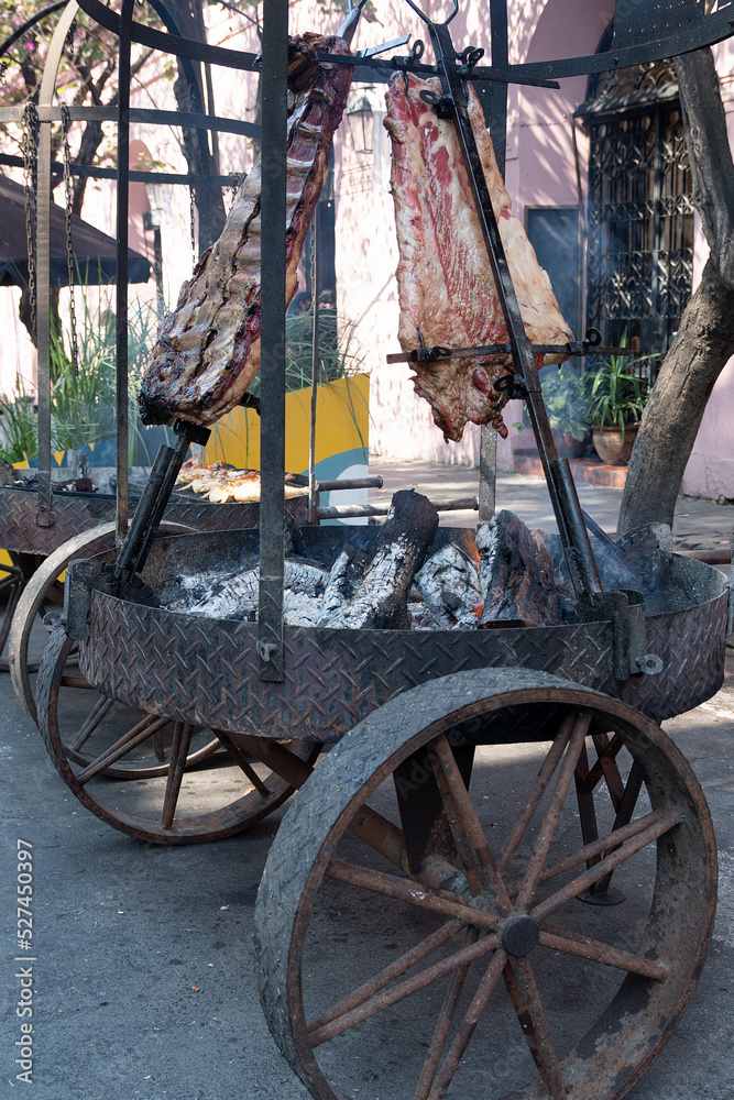 Asado argentino, typical Argentinean barbecue with ribs on vertical ...