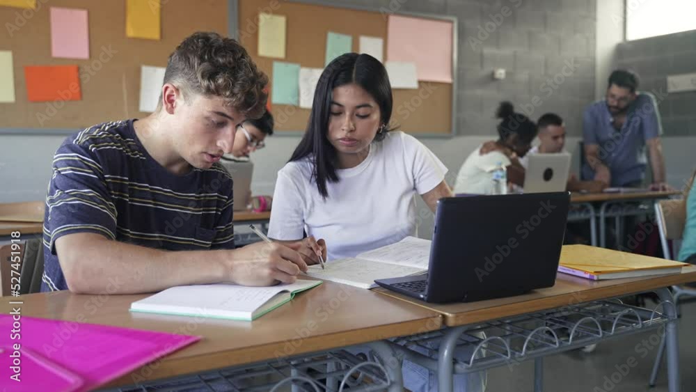 Teenager classmates friends doing exercise and working together in the Secondary School Classroom - Multi ethnic caucasian and Latin American students Teenager classmates friends doing exercise and working together in the Secondary School Classroom - Multi ethnic caucasian and Latin American students