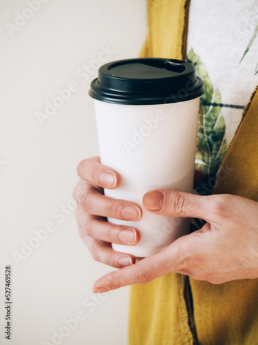 Female Hands Holding Paper Cup Of Coffee For Logo On White Background. Lifestyle