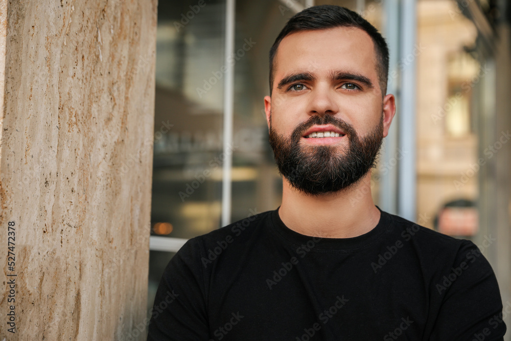 Portrait of happy handsome man near building outdoors. Space for text Portrait of happy handsome man near building outdoors. Space for text