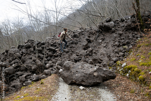 Woman Backpacker Hiker  Found Herself Facing an Interrupted Road in the Mountains due to an Avalanche - Tolminka valley Slovenia photo