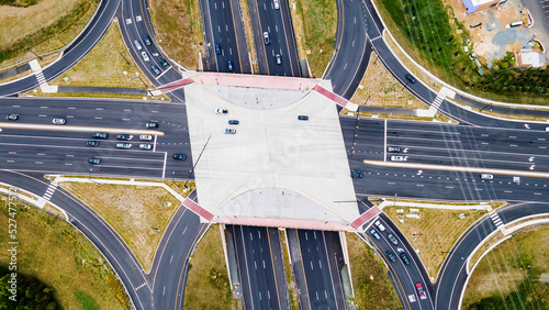 From above, aerial view of a new interchange in the city of Leesburg, Virginia. Modern building design of the roadway to avoid traffic jams. Few cars.
