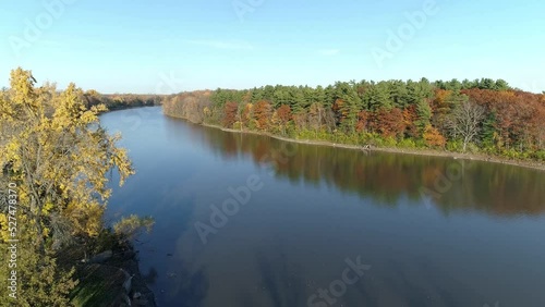 Drone crane shot coming down over the shore of the river in Rosemere on a clear sunny day of Autumn photo