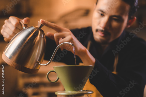 hipster barista pouring a h...
