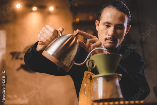 hipster barista pouring a h...