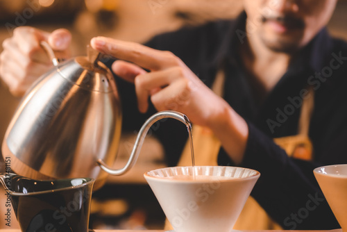 hipster barista pouring a h...
