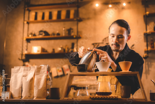 hipster barista pouring a h...