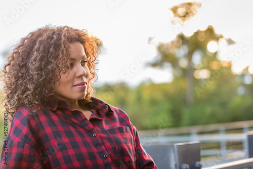 Woman in her thirties thinking as the sun sets. High quality photo