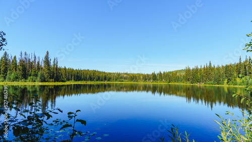 Reflections on tranquil lake in Northern BC, on a perfect summer day.
