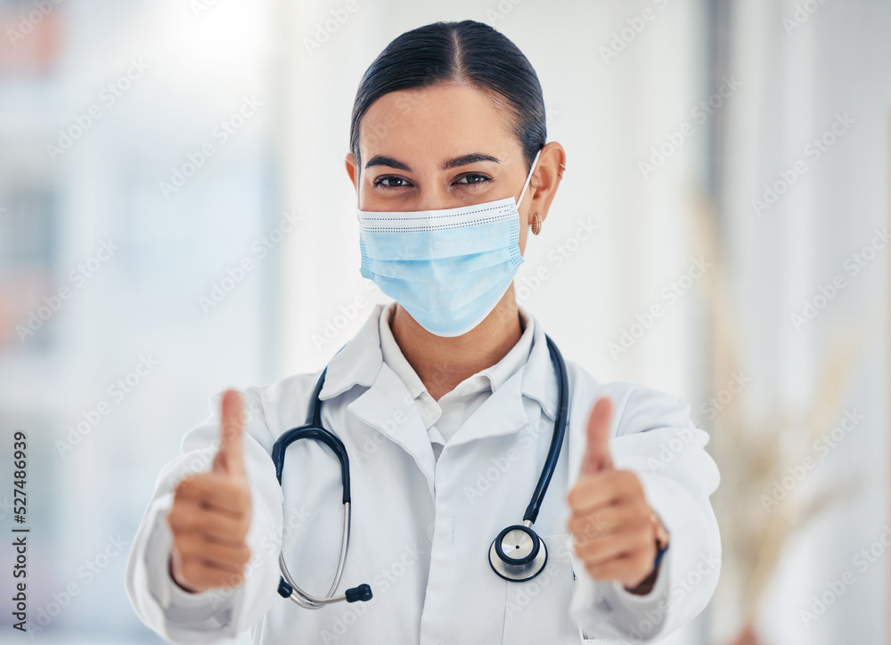 Covid, portrait and thumbs up doctor with mask happy with hospital hygiene for infection safety. Healthcare woman with hand gesture of success for virus prevention in consultation room. Covid, portrait and thumbs up doctor with mask happy with hospital hygiene for infection safety. Healthcare woman with hand gesture of success for virus prevention in consultation room.