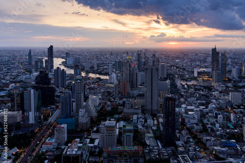 View of downtown Bangkok at sunset with Chao Praya river in the background , city skyline