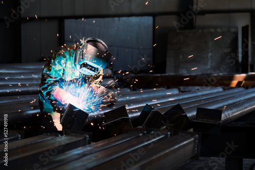 Industrial welder welding metal profiles