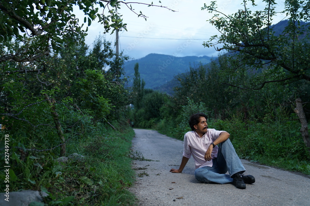 person sitting on a bench in the forest person sitting on a bench in the forest