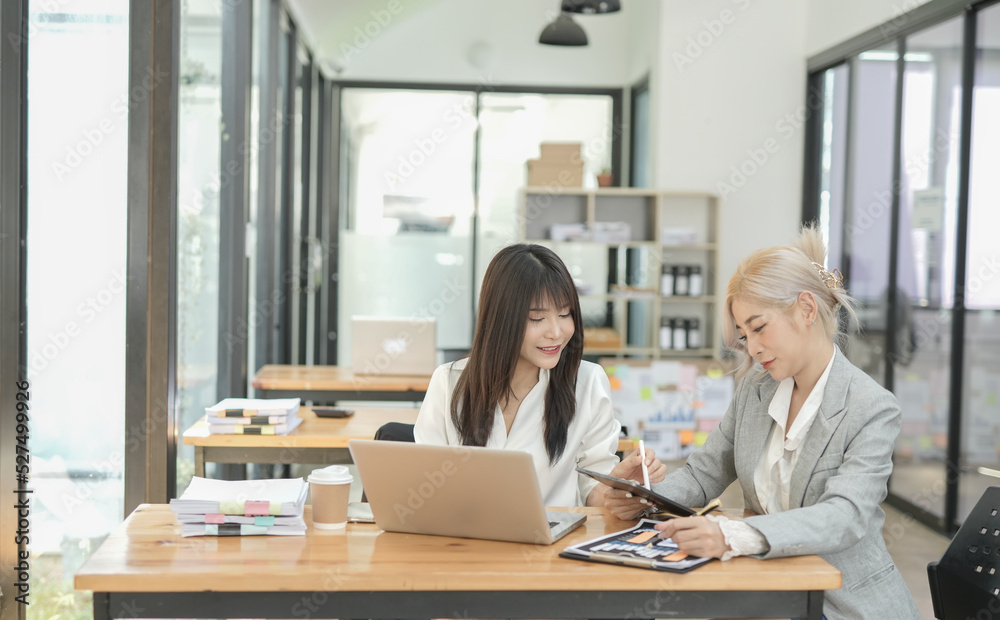 Asian businesswoman using calculator and financial documents at the table office, business financial concept. Asian businesswoman using calculator and financial documents at the table office, business financial concept.
