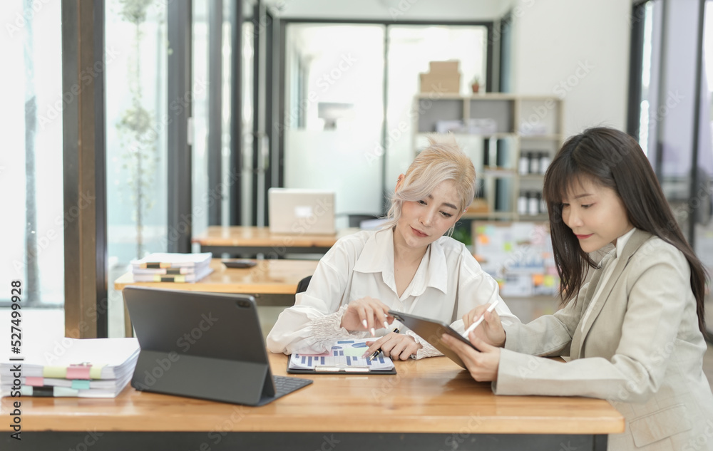 Asian businesswoman using calculator and financial documents at the table office, business financial concept. Asian businesswoman using calculator and financial documents at the table office, business financial concept.