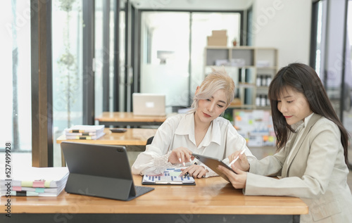 Asian businesswoman using calculator and financial documents at the table office, business financial concept.