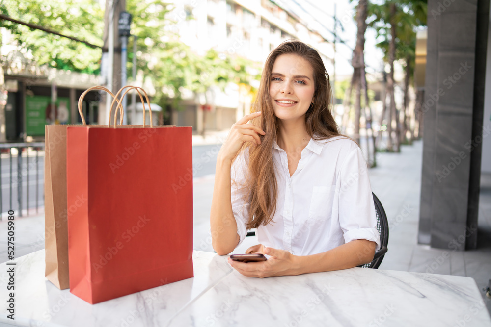 Grocery stores are happy that women go shopping.woman sitting on the street.woman's lifestyle is shopping in the city . Grocery stores are happy that women go shopping.woman sitting on the street.woman's lifestyle is shopping in the city .