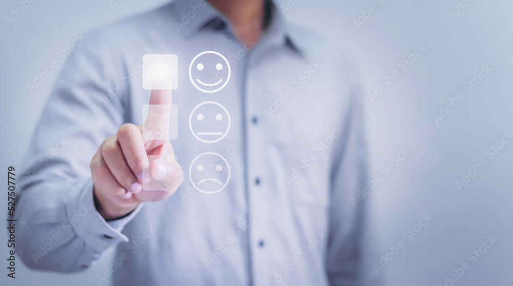 Customer service and Satisfaction concept ,Business is touching the virtual screen on the happy Smiley face icon to give satisfaction in service.Customer service experience and rating very impressed. Customer service and Satisfaction concept ,Business is touching the virtual screen on the happy Smiley face icon to give satisfaction in service.Customer service experience and rating very impressed.