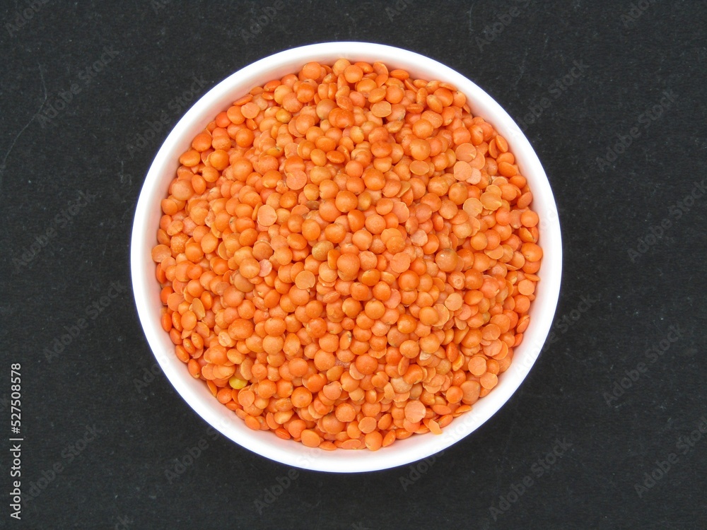 Red lentil in a bowl top view Red lentil in a bowl top view