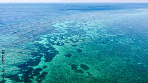 Aerial view of vast coral reef of Coral Triangle in crystal clear turquoise ocean water in Timor Leste, Southeast Asia, drone of seascape environment from above