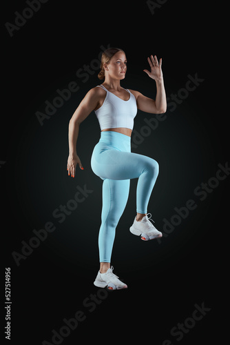 Shot female gymnast performing exercise postures for an app and online classes