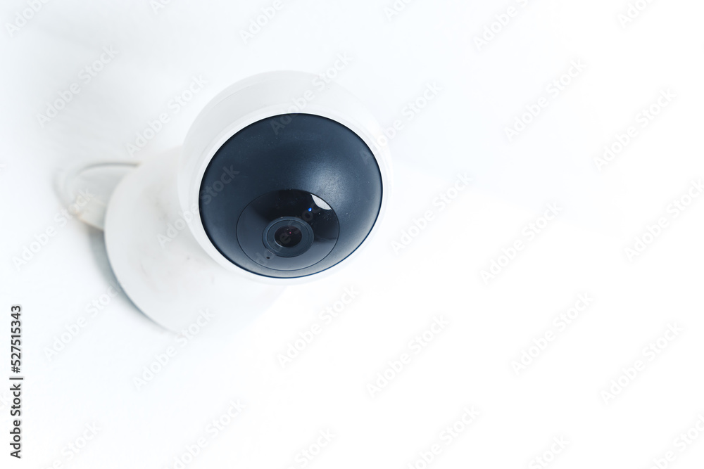 Isolated modern surveillance IP camera on a white wall. High quality photo Isolated modern surveillance IP camera on a white wall. High quality photo