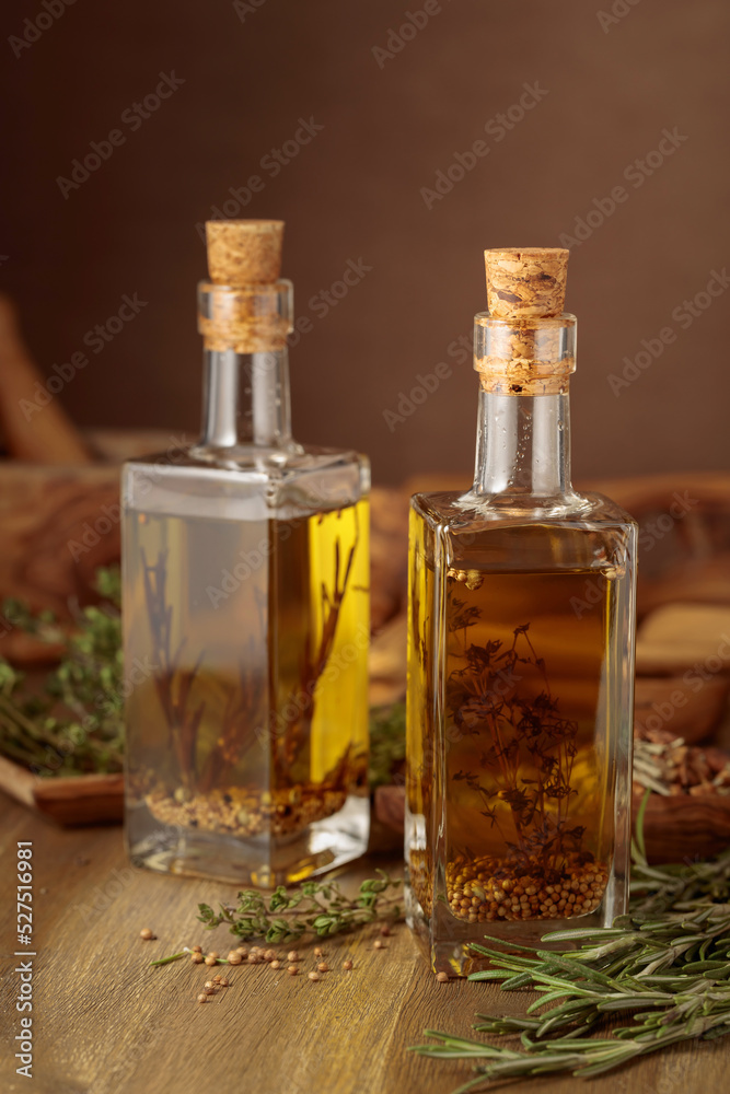 Bottles of olive oil with herbs and spices. Bottles of olive oil with herbs and spices.