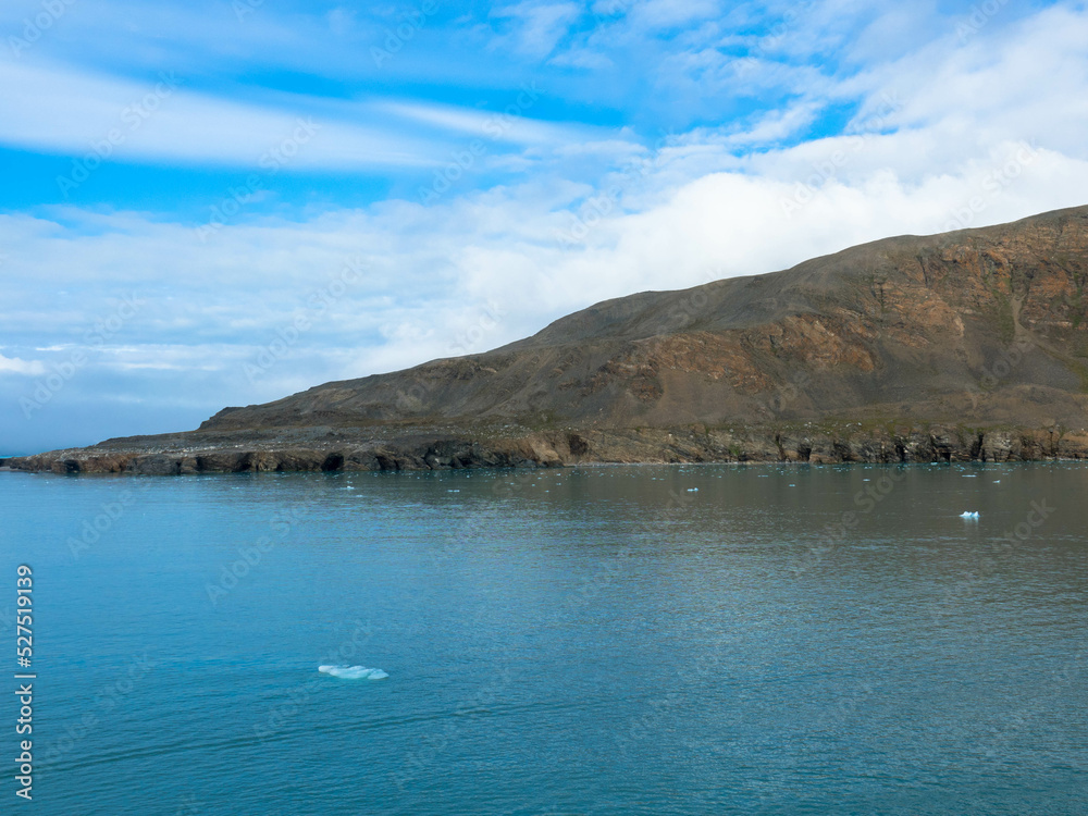 Palanderbukta is a fjord in Gustav Adolf Land in Nordaustlandet, Spitsbergen, a southern bay of the Wahlenbergfjord. Arctic mountain desert and arctic ocean. Svalbard, Norway Palanderbukta is a fjord in Gustav Adolf Land in Nordaustlandet, Spitsbergen, a southern bay of the Wahlenbergfjord. Arctic mountain desert and arctic ocean. Svalbard, Norway