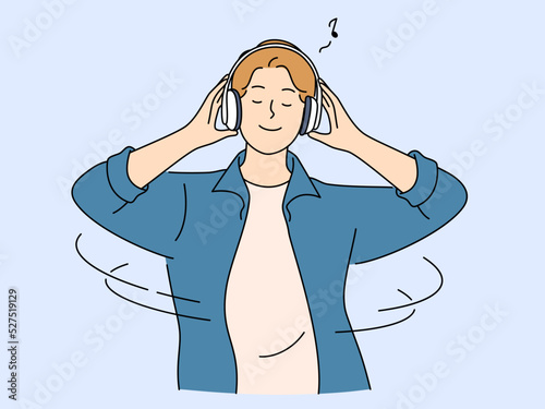 Happy man listen music in earphones 