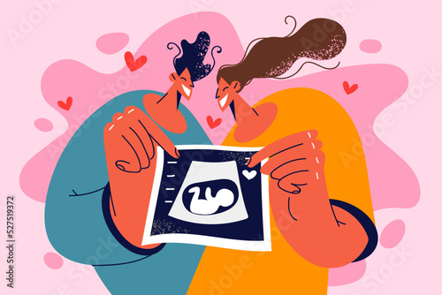 Happy couple show ultrasound scan 