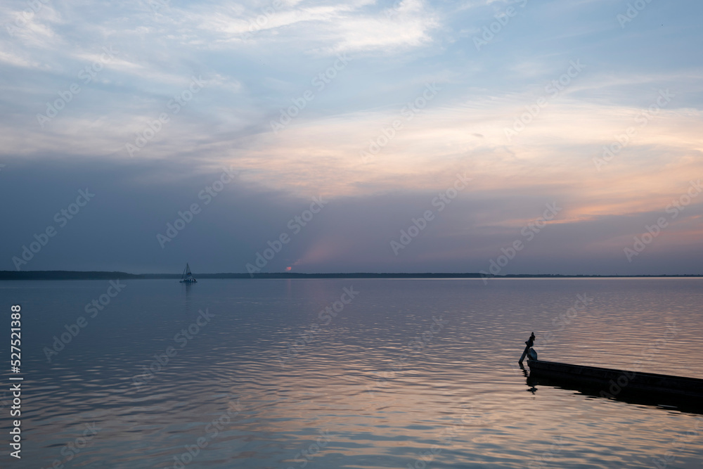 Naklejka premium Boat on the shore of the lake. Beach by the lake