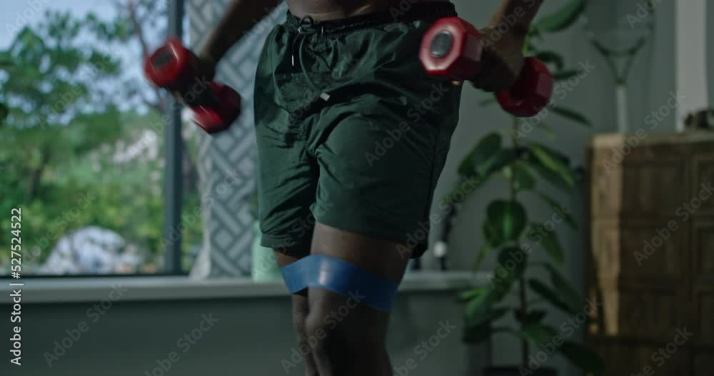 African american male doing physical exercise with elastic bands and dumbbellsat home. Fitness African american male doing physical exercise with elastic bands and dumbbellsat home. Fitness