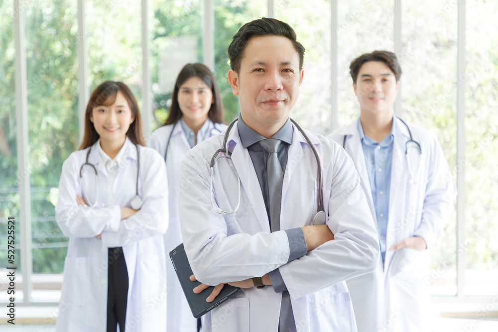 Medicine and healthcare concept : Group of serious asian doctors Line up, Male and Female are standing in lobby of hospital. Medicine and healthcare concept : Group of serious asian doctors Line up, Male and Female are standing in lobby of hospital.