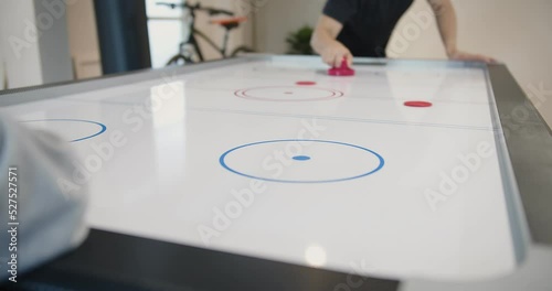 people players playing air hockey game on the table together and having fun competition leisure sport photo