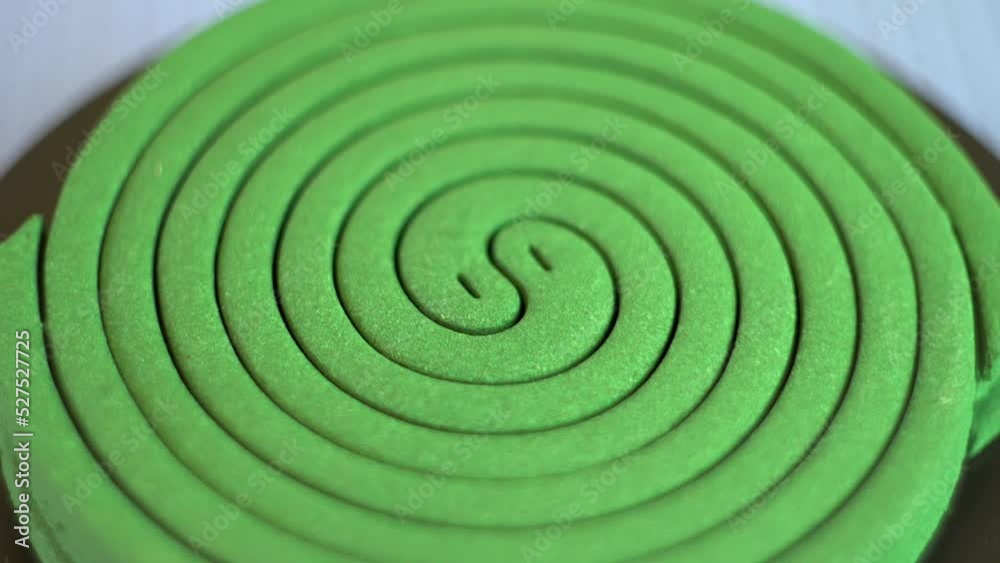 Mosquito repellent. Green spiral. Destruction of insects. Human protection. Comfort in the house. Rotation of an object. Close-up.