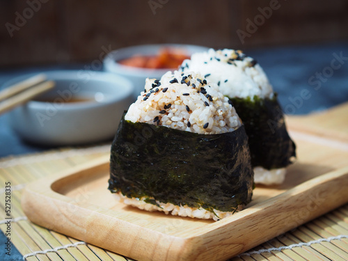 Onigiri Japanese traditional food, steamed rice in triangle shape wrap with seaweed.