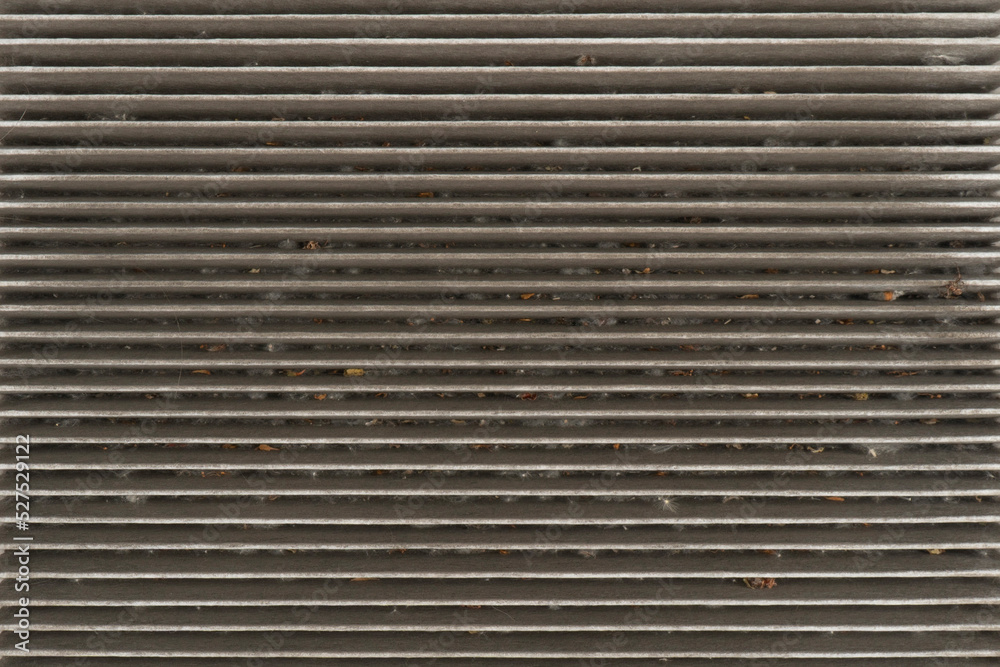 Obraz premium Used car cabin charcoal air filter texture background. Dirty carbon car air filter with dust pattern.