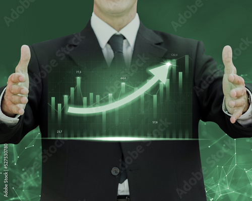 businessman showing a growing virtual hologram stock graph between the hands photo