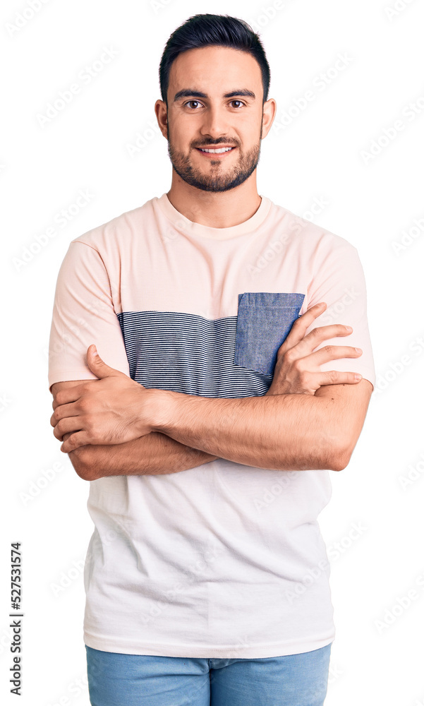 Young handsome man wearing casual clothes happy face smiling with crossed arms looking at the camera. positive person. Young handsome man wearing casual clothes happy face smiling with crossed arms looking at the camera. positive person.