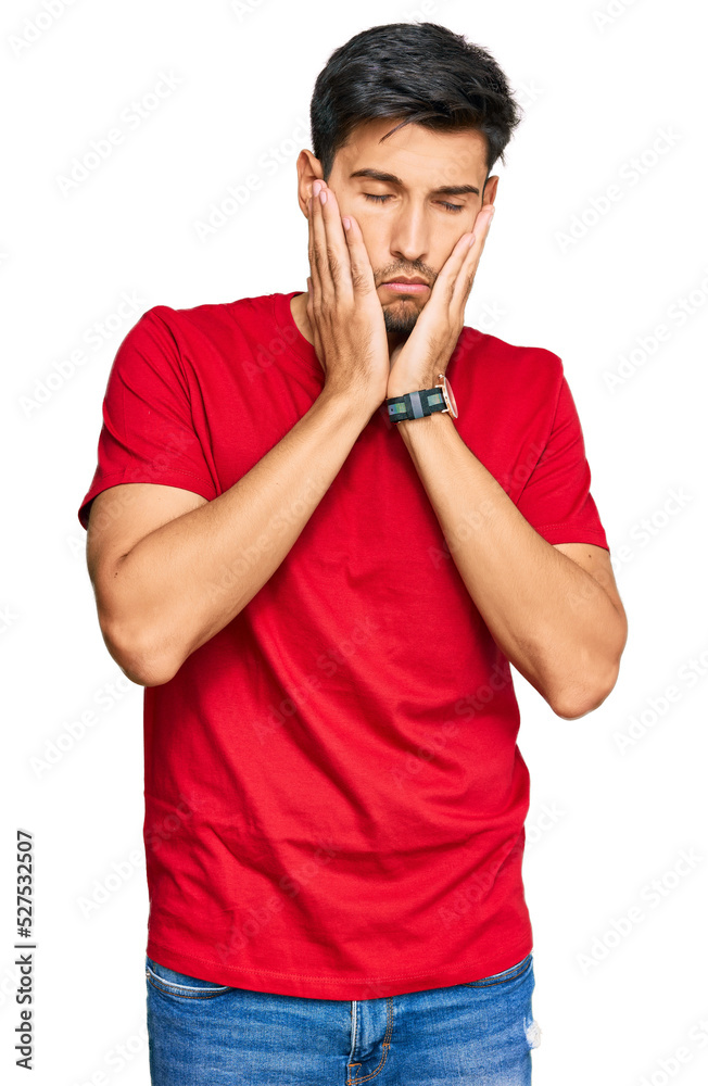 Young handsome man wearing casual red tshirt tired hands covering face, depression and sadness, upset and irritated for problem Young handsome man wearing casual red tshirt tired hands covering face, depression and sadness, upset and irritated for problem