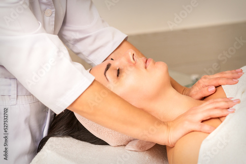 Young caucasian woman with closed eyes getting a chest massage in a beauty clinic