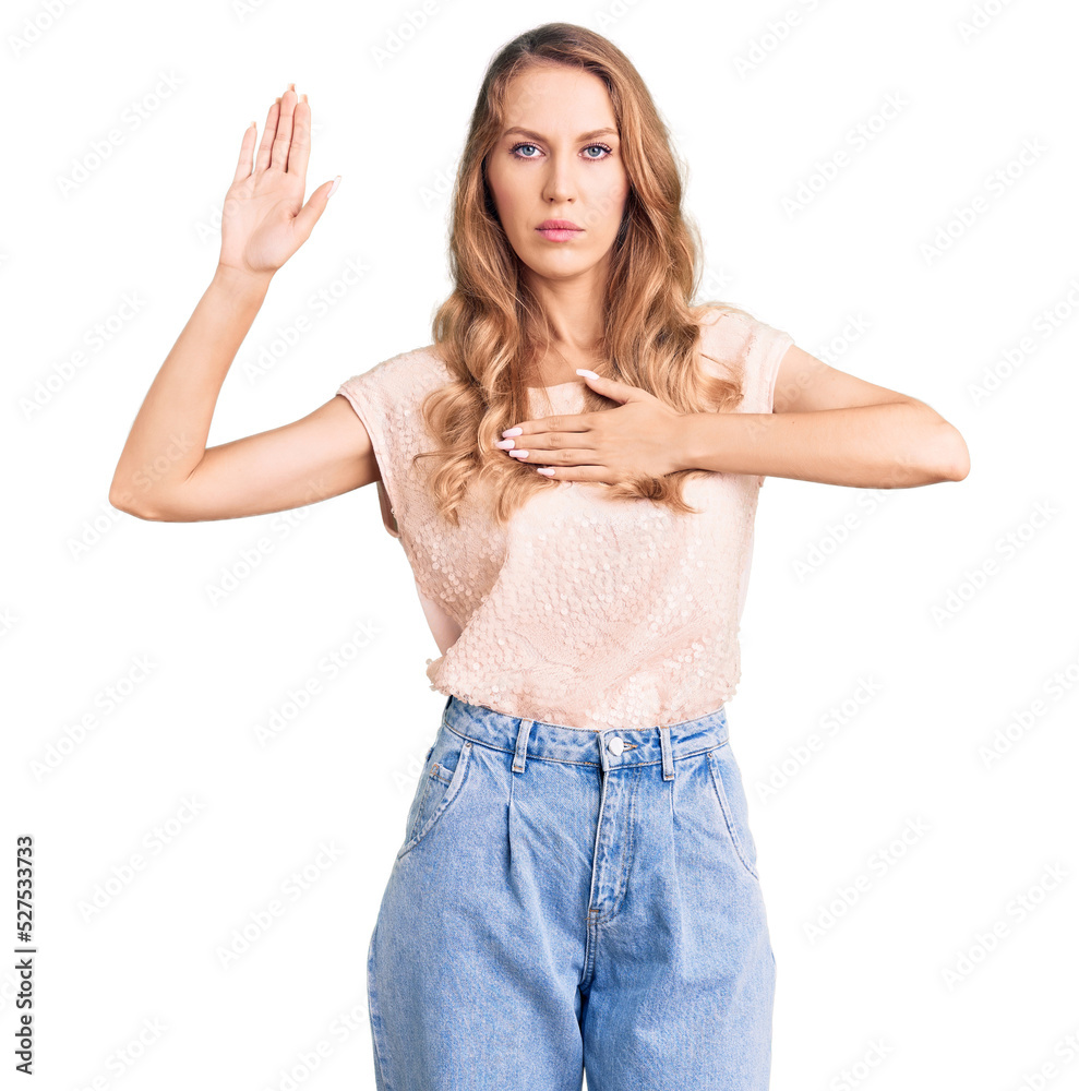 Young beautiful caucasian woman with blond hair wearing casual clothes swearing with hand on chest and open palm, making a loyalty promise oath Young beautiful caucasian woman with blond hair wearing casual clothes swearing with hand on chest and open palm, making a loyalty promise oath