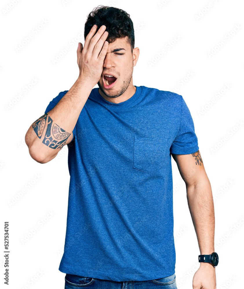 Young hispanic man wearing casual t shirt yawning tired covering half face, eye and mouth with hand. face hurts in pain. Young hispanic man wearing casual t shirt yawning tired covering half face, eye and mouth with hand. face hurts in pain.