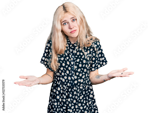 Young caucasian woman together clueless and confused expression with arms and hands raised. doubt concept.