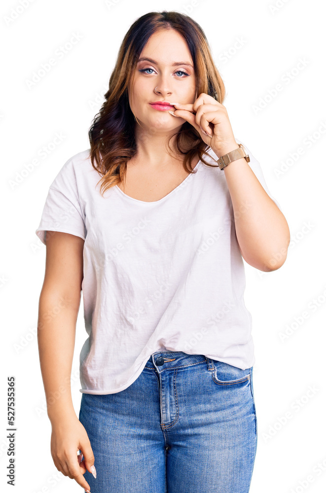 Young beautiful caucasian woman wearing casual white tshirt mouth and lips shut as zip with fingers. secret and silent, taboo talking Young beautiful caucasian woman wearing casual white tshirt mouth and lips shut as zip with fingers. secret and silent, taboo talking