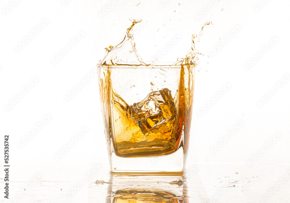 Isolated shot of whiskey with splash on black background Isolated shot of whiskey with splash on black background