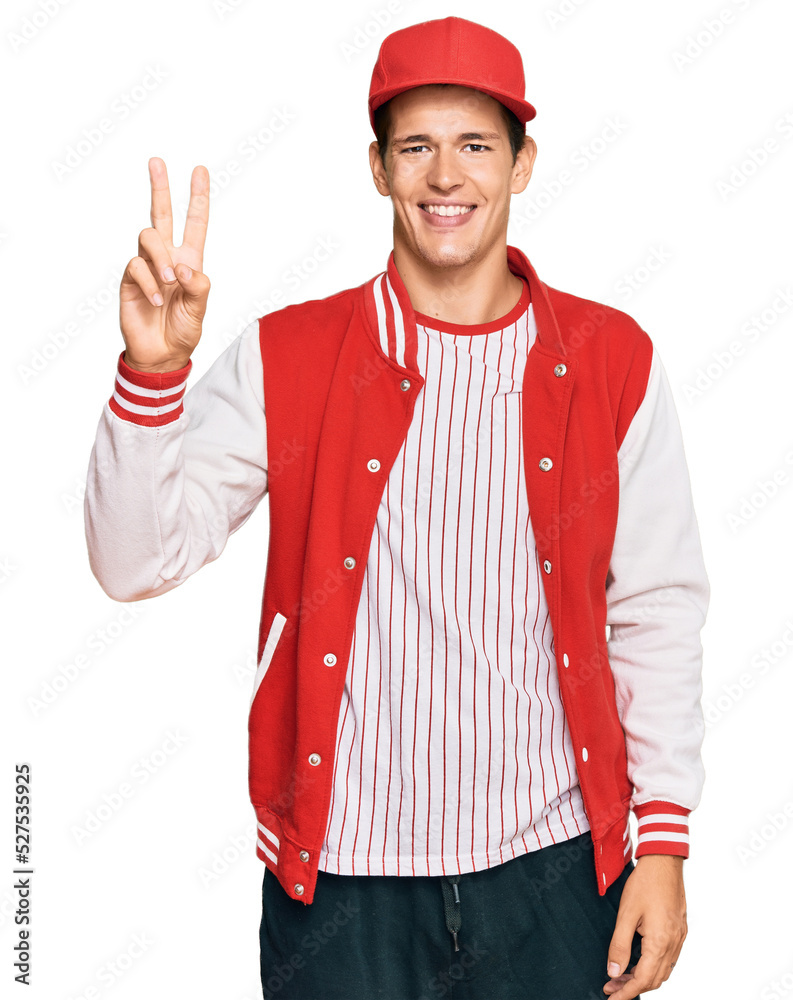 Handsome caucasian man wearing baseball uniform showing and pointing up with fingers number two while smiling confident and happy. Handsome caucasian man wearing baseball uniform showing and pointing up with fingers number two while smiling confident and happy.