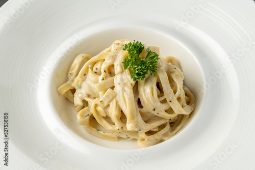 Photography Freshly made fettucini alfredo on a white porcelain plate